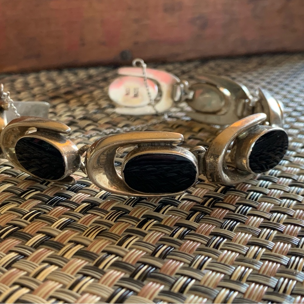 Sterling Silver: marked 925 & artist MD. Heavy oval onyx links. Safety chain.